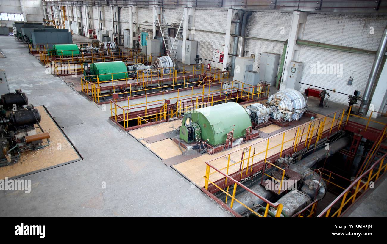 Interior of chemical enterprise shows high-pressure turbo compressors for supplying air separation units. Large mechanical facility powerful units for Stock Photo