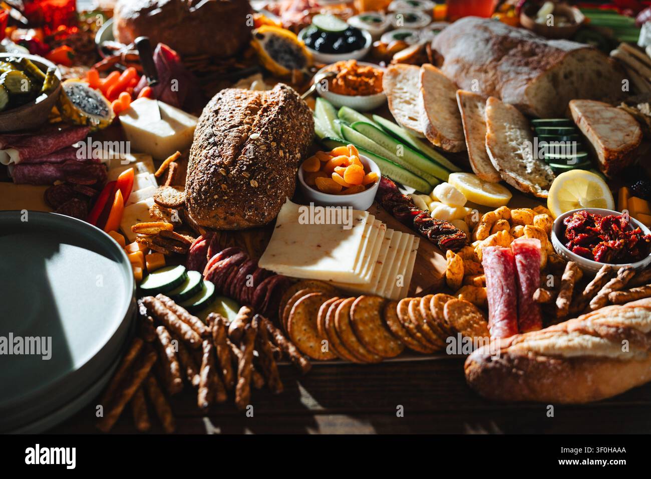 Gourmet abundant charcuterie board with assorted breads and appetizers Stock Photo