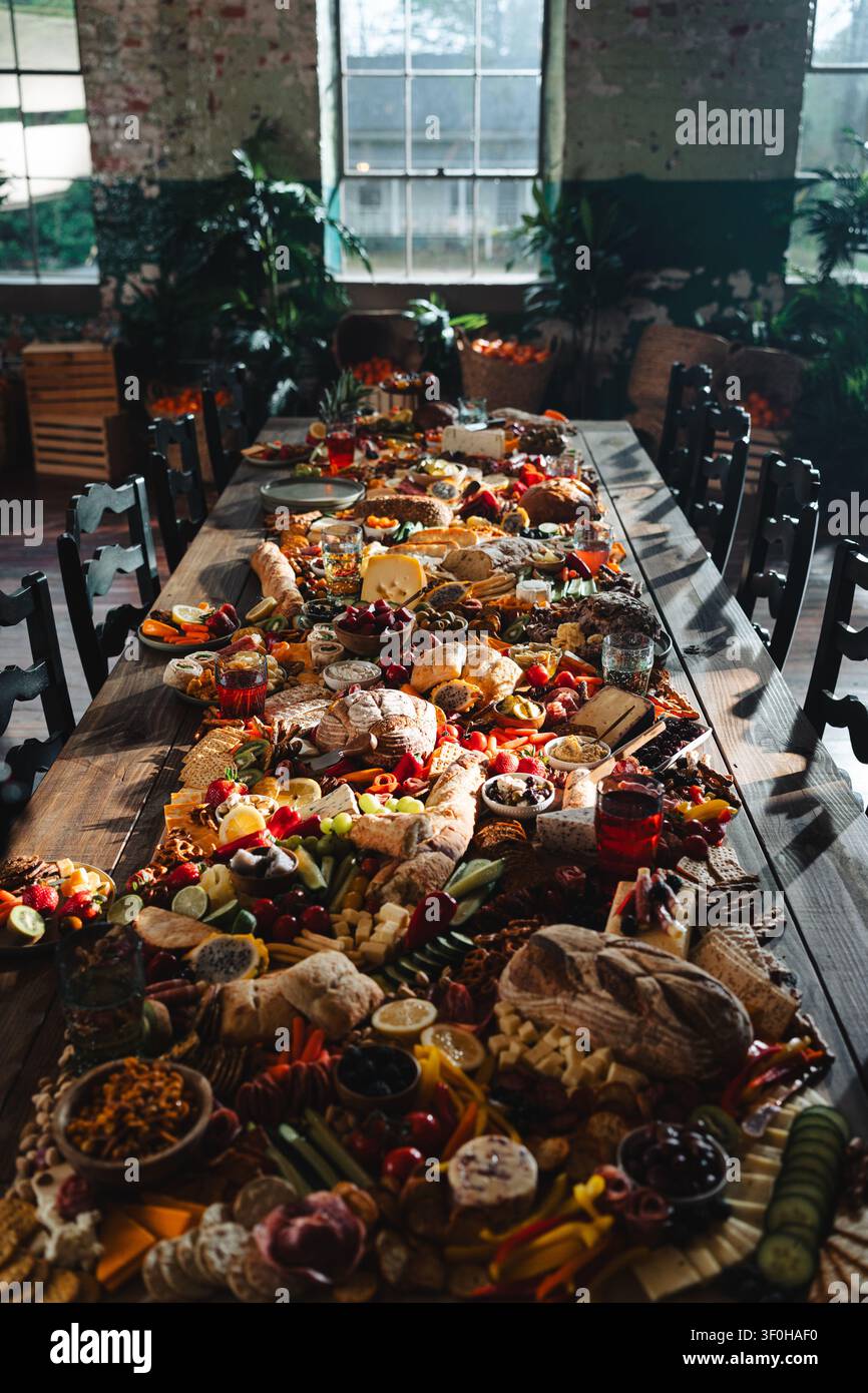 Large rustic grazing table with assorted food and bread Stock Photo