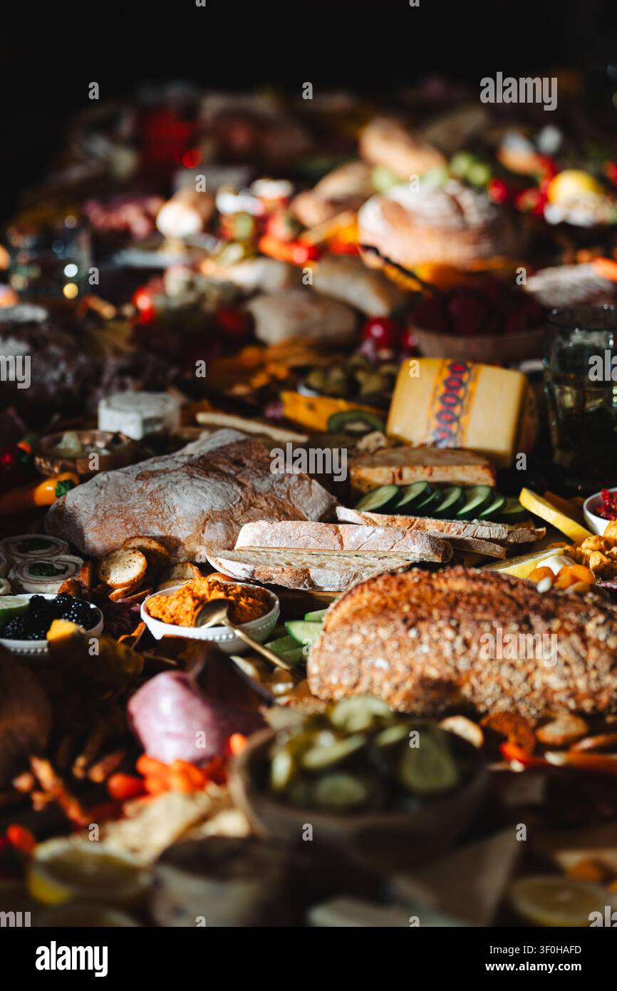 Large rustic grazing board with assorted breads cheese and appetizers Stock Photo