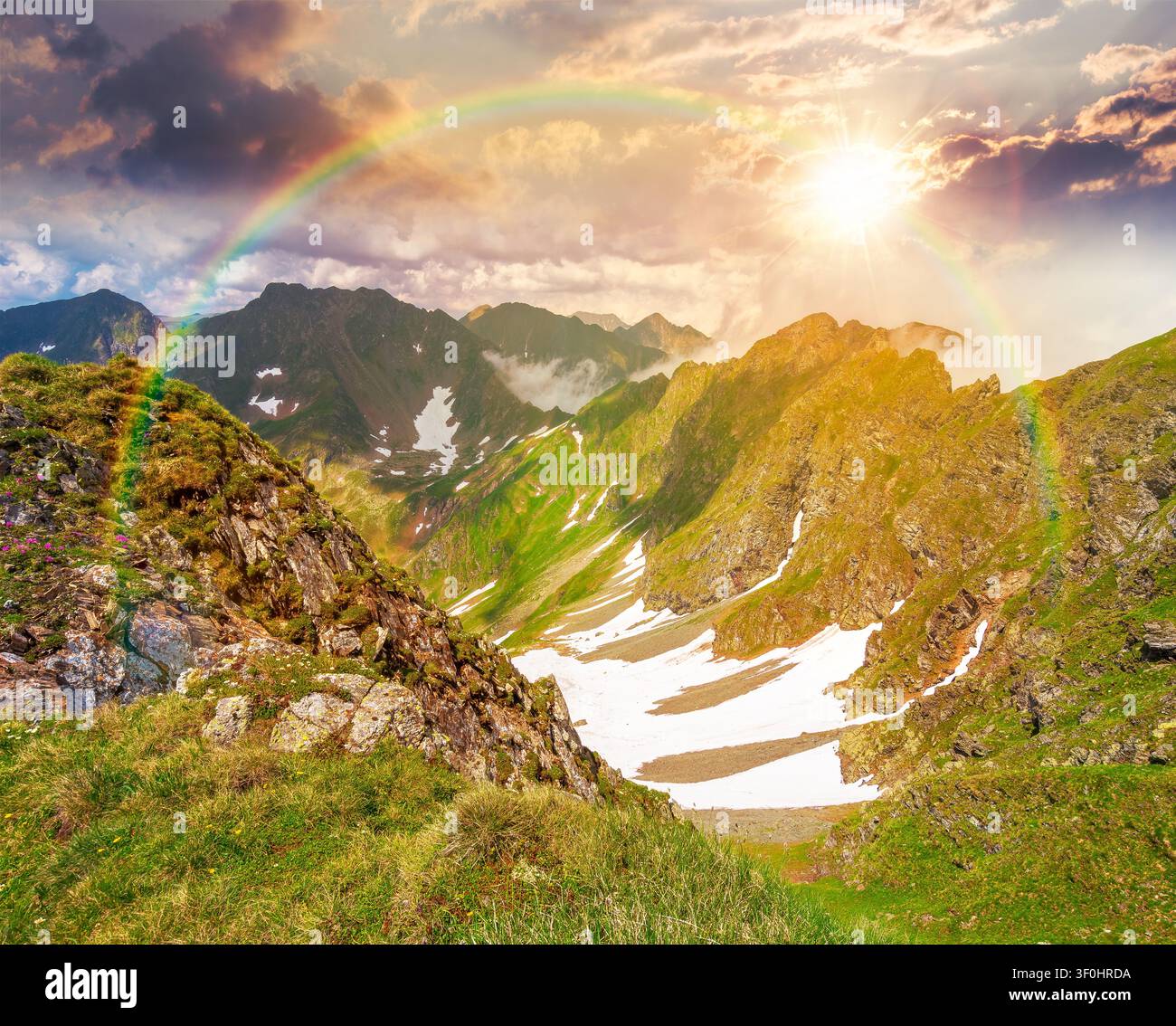sunset over romania mountain landscape in summer. travel background of alpine scenery in fagaras mountain ridge in evening light. european summer outd Stock Photo