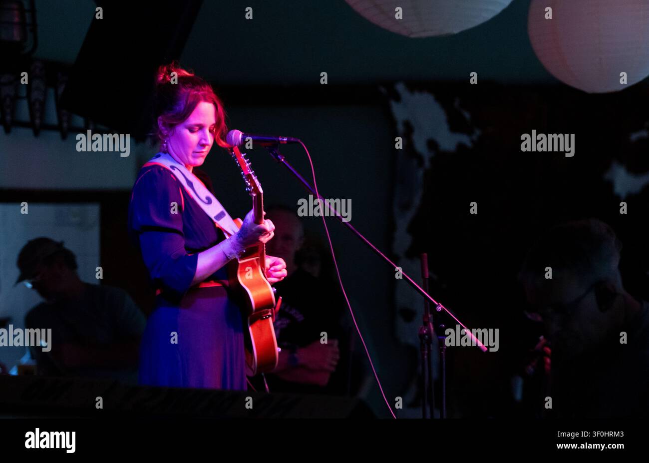 Lovely sunny weather for the 19th Maverick long weekend Americana music festival held in Eaton Farm Park in rural Suffolk and Holly Carter on stage. Stock Photo