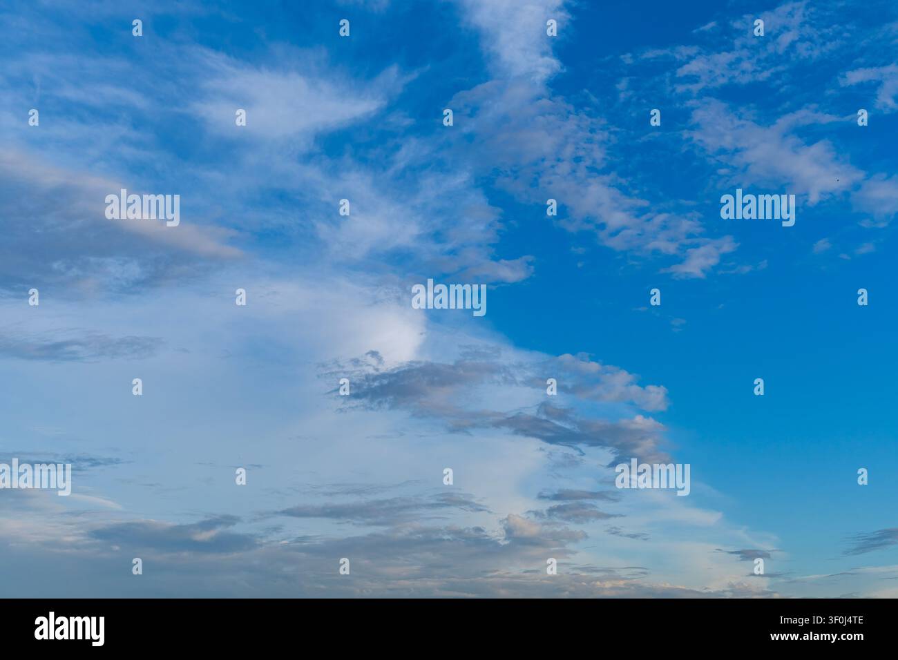 Dramatic storm clouds spreading across blue sky before rain Stock Photo