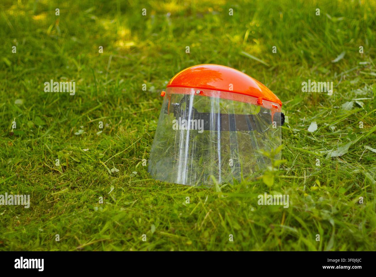 Protective face shield on grass Stock Photo