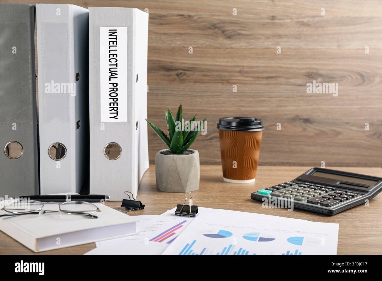 Intellectual property. Folders, documents and stationery on wooden table Stock Photo