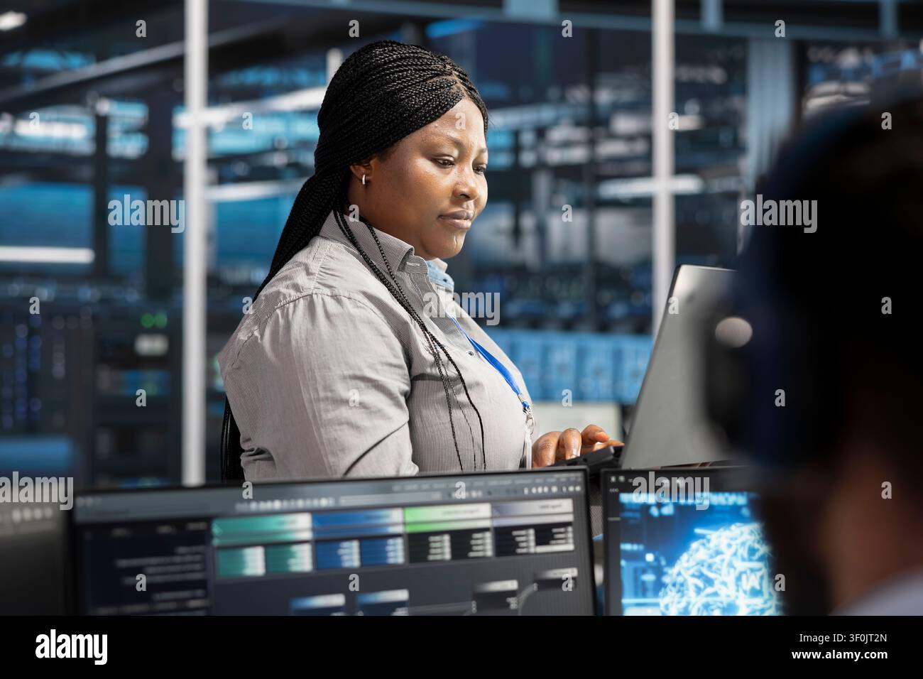 Server facility software engineer applying AI neural network models tech. Stock Photo