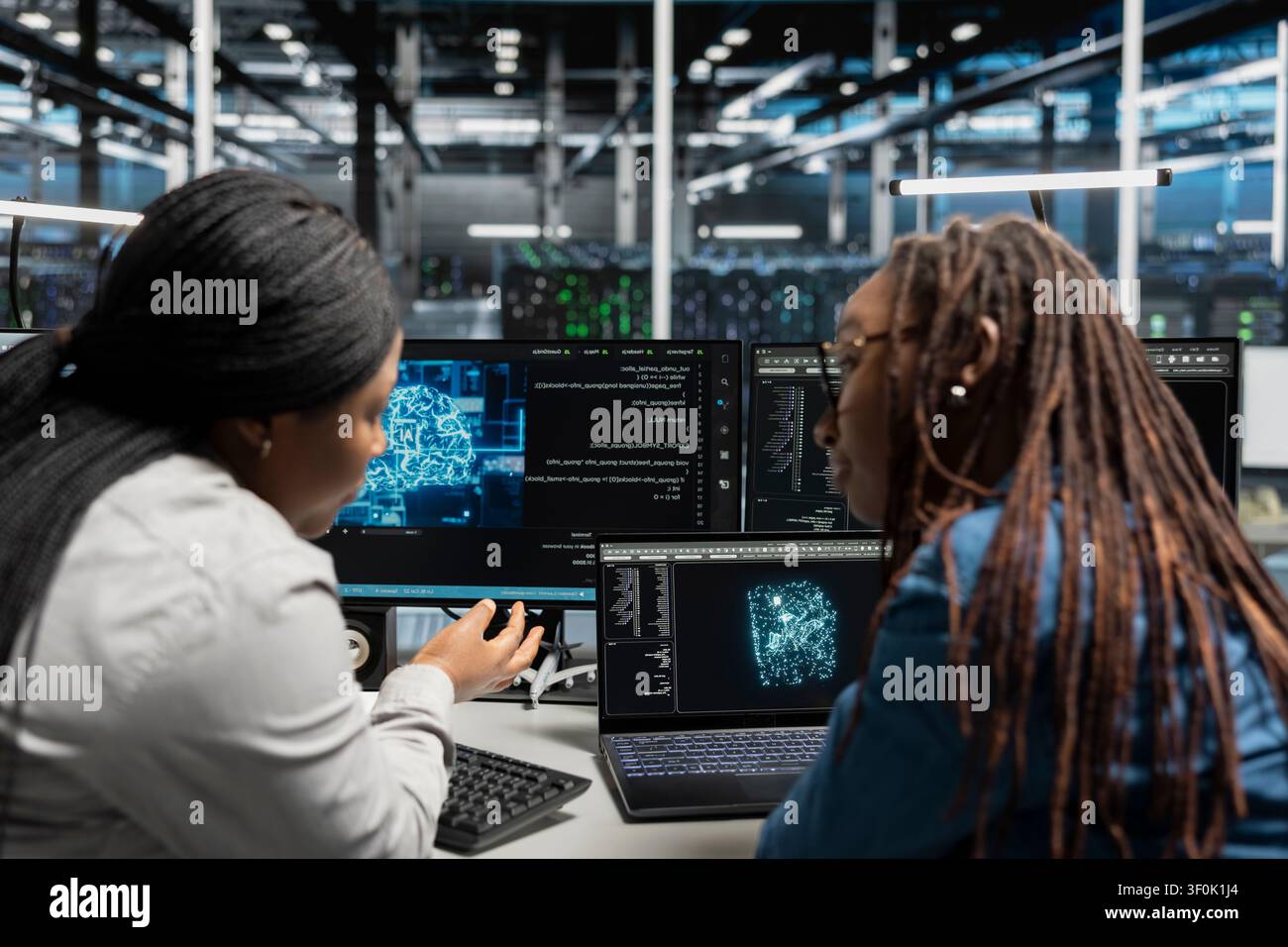 Engineers collaborating, inspecting neural network server room used for machine learning. Stock Photo