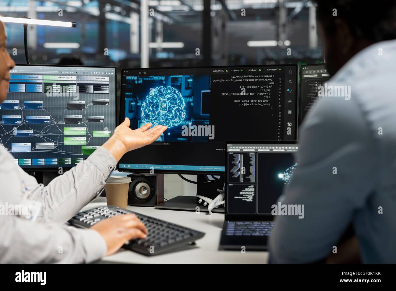 Engineering team inspecting neural network server room used for machine learning. Stock Photo
