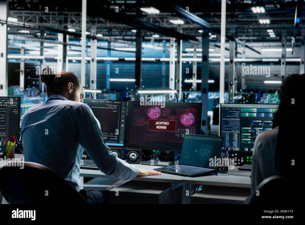 Teamworking server room admins try to fix system faults working with AI tools. Stock Photo
