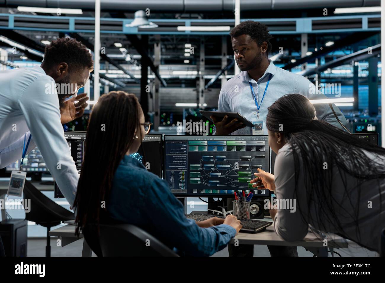 System administrators run code on a PC in an AI data center to upgrade artificial intelligence systems for machine learning training. Stock Photo