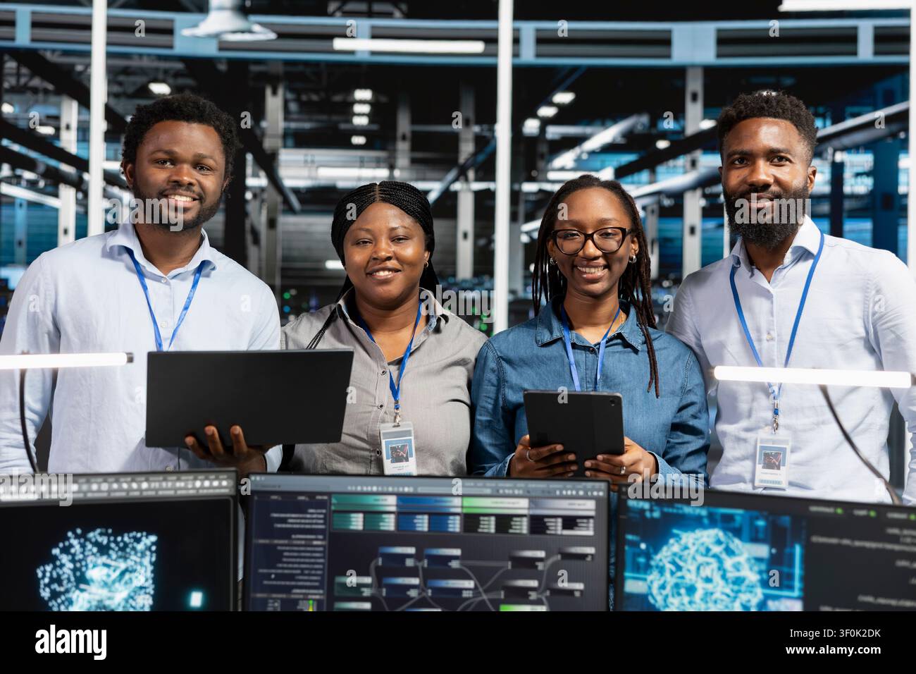 Happy data center team reviews data analysis graph to reduce equipment failure. Stock Photo