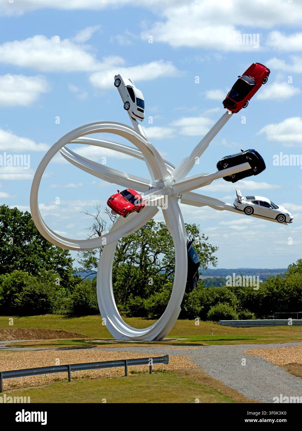 Porsche 911 cars mounted on Gerry Judah’s looping 21-metre sculpture at the Porsche Experience Centre, Silverstone Stock Photo