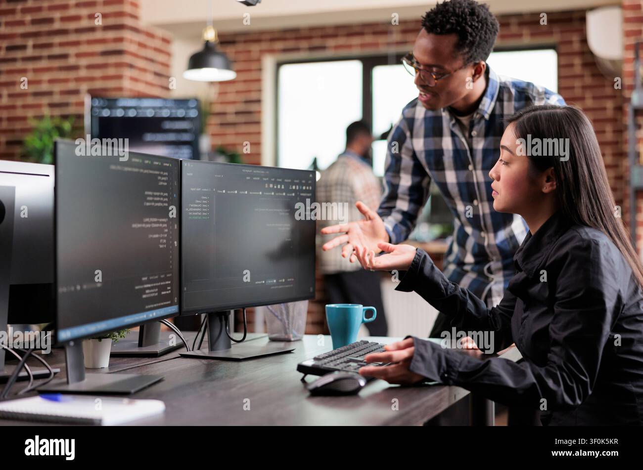 Multiethnic cyber security team developing software algorithm for information processing combines data protection, software systems and secure infrastructure in a technology workspace. Stock Photo