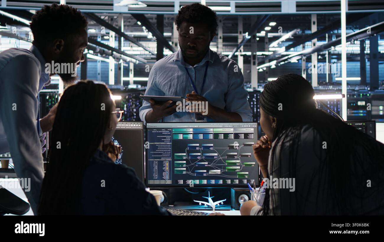 Server room coworkers doing planning solutions, working with node tree software to review data sets. Stock Photo
