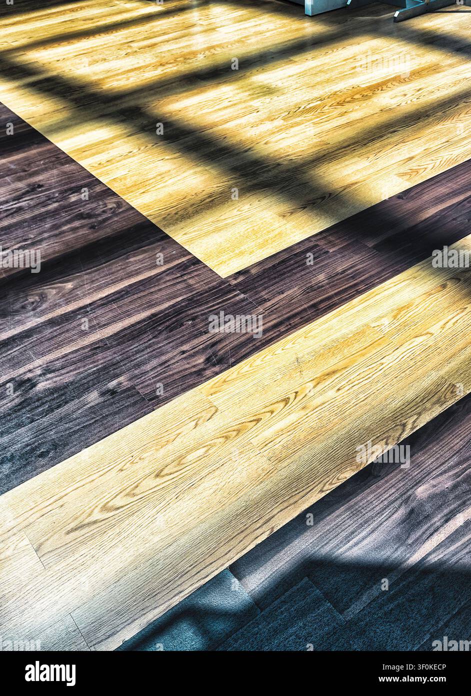 Long shadows spread across a floor Stock Photo
