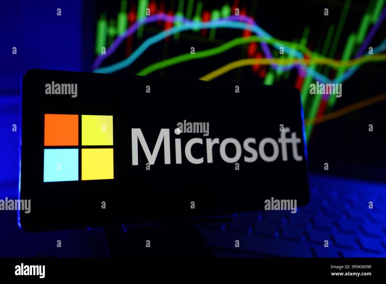 Microsoft Technology Software and Cloud Computing Company Logo on Smartphone Display with Stock Market Performance Chart Stock Photo