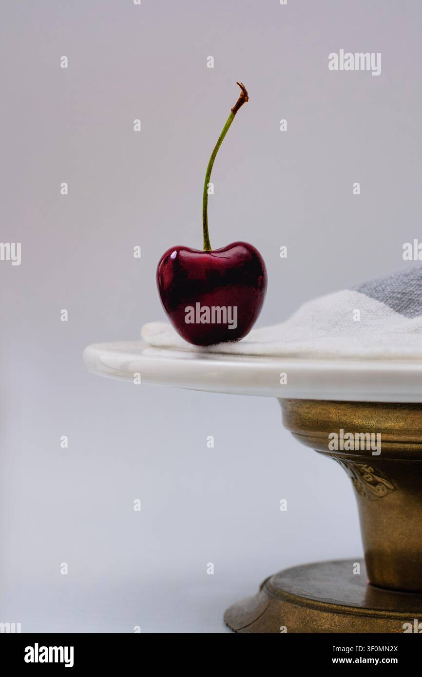 Dark red cherry on a cake tray Stock Photo