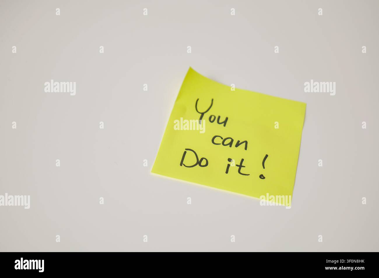 Yellow Sticky Note with You Can Do It on White Background Stock Photo