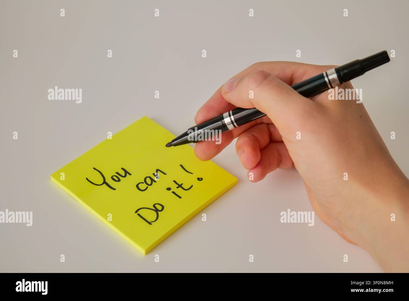 Hand Writing You Can Do It on Yellow Sticky Note Stock Photo
