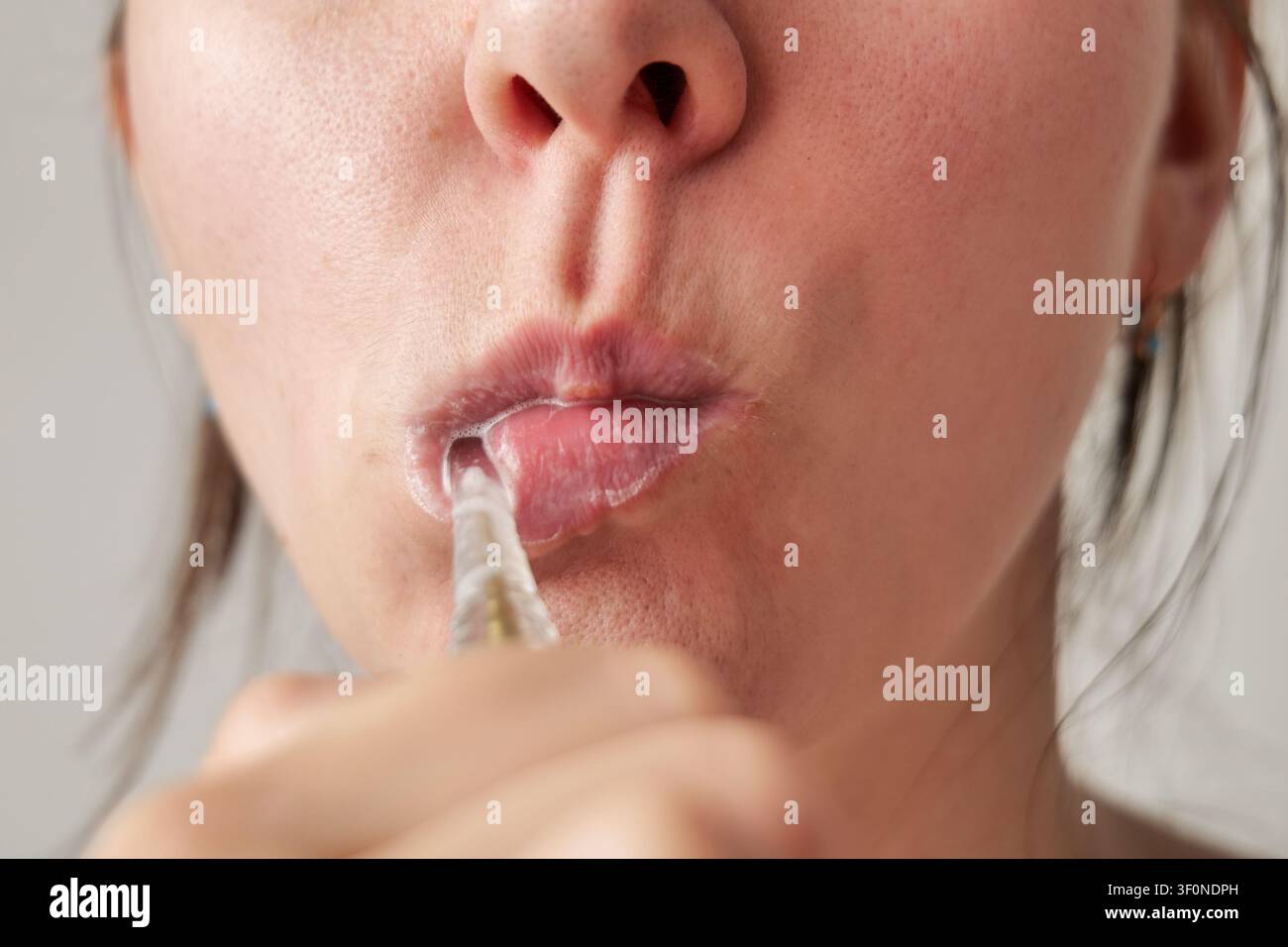 Young Woman Brushing Teeth with Toothbrush Stock Photo