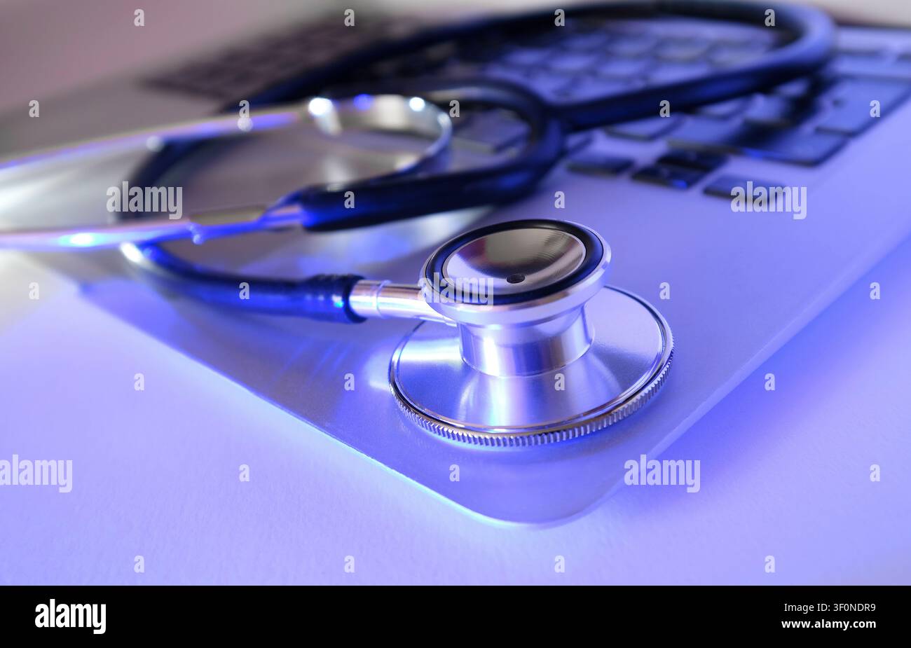 doctor's stethoscope on laptop keyboard Stock Photo