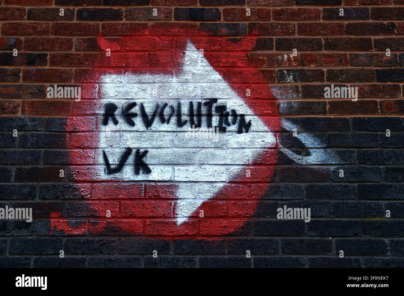 Slogan Painted on Brick wall ' Revolution UK' Stock Photo