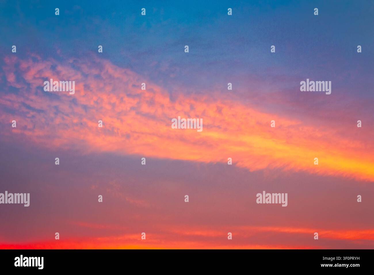 sky at sunset for background. red clouds on the blue sky. nature backdrop in evening light Stock Photo