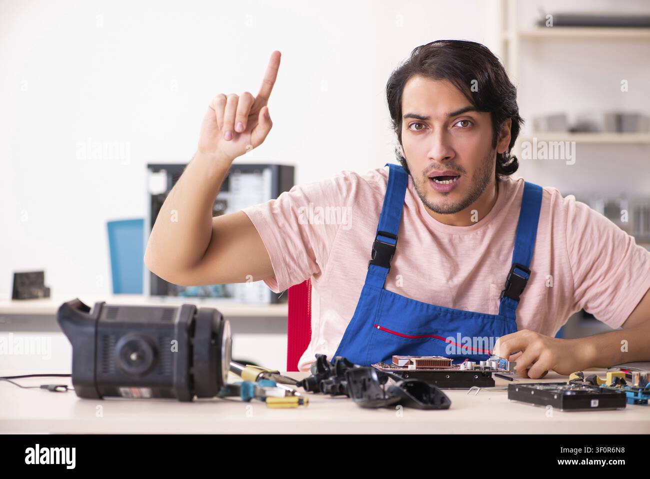 Young male contractor repairing computer Stock Photo