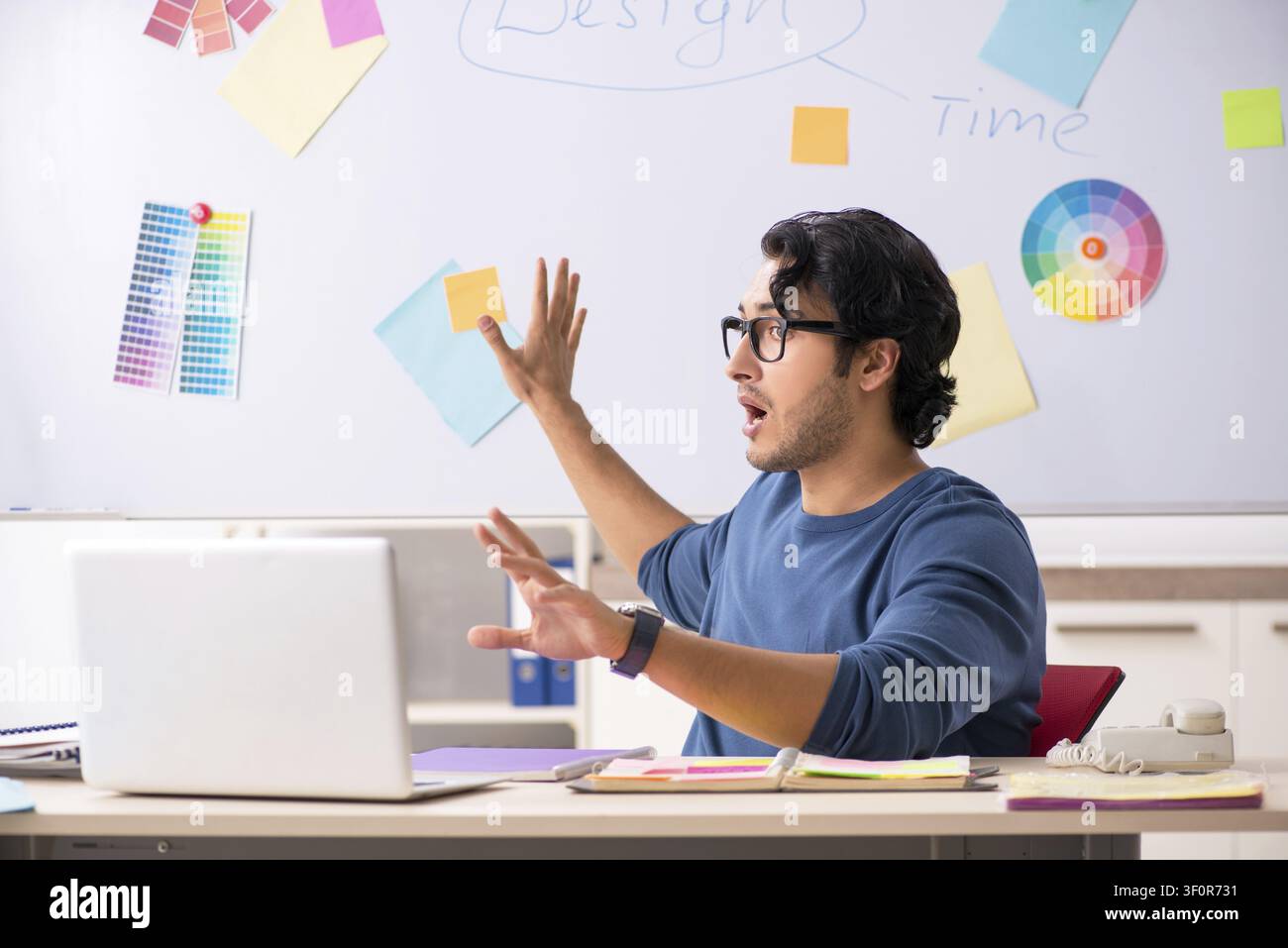 Young handsome designer working at the project Stock Photo