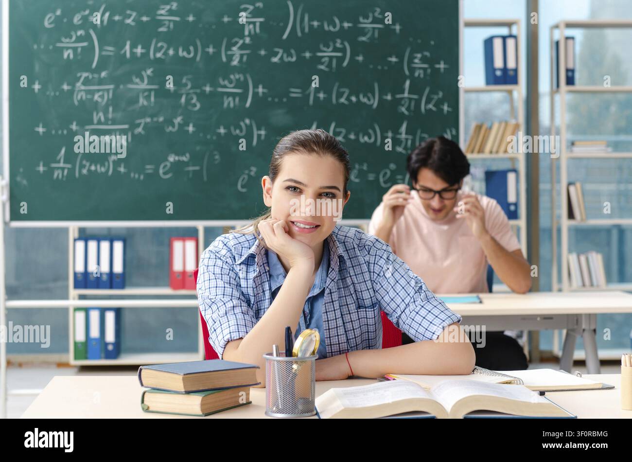 Young students taking the math exam in classroom Stock Photo