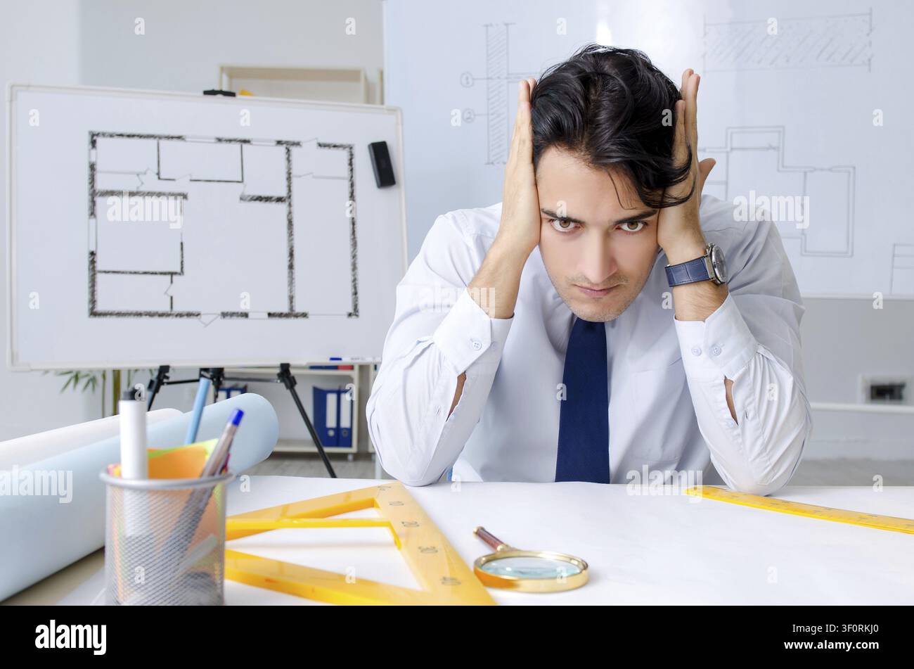 Young handsome architect working on the project Stock Photo