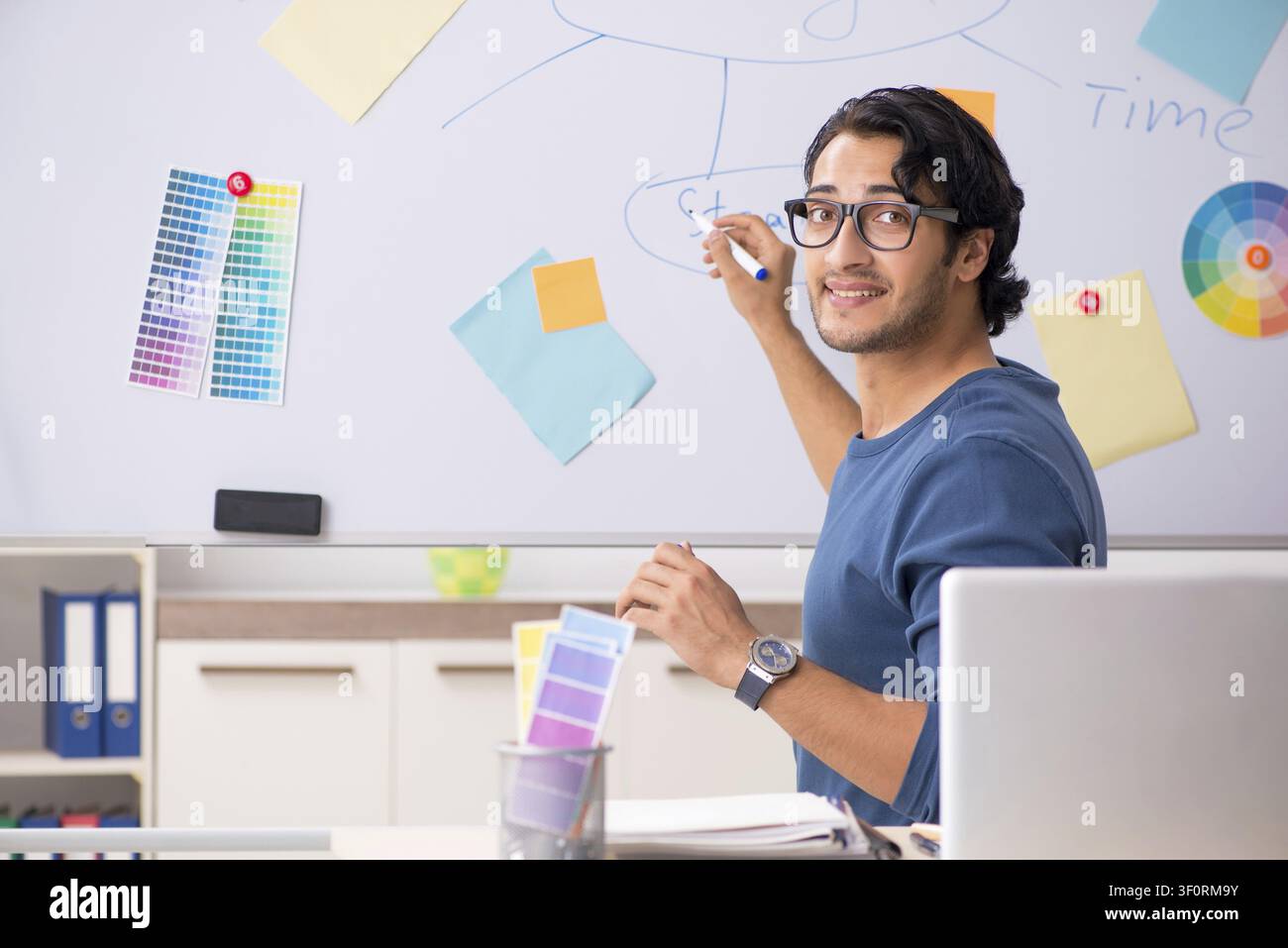 Young handsome designer working at the project Stock Photo