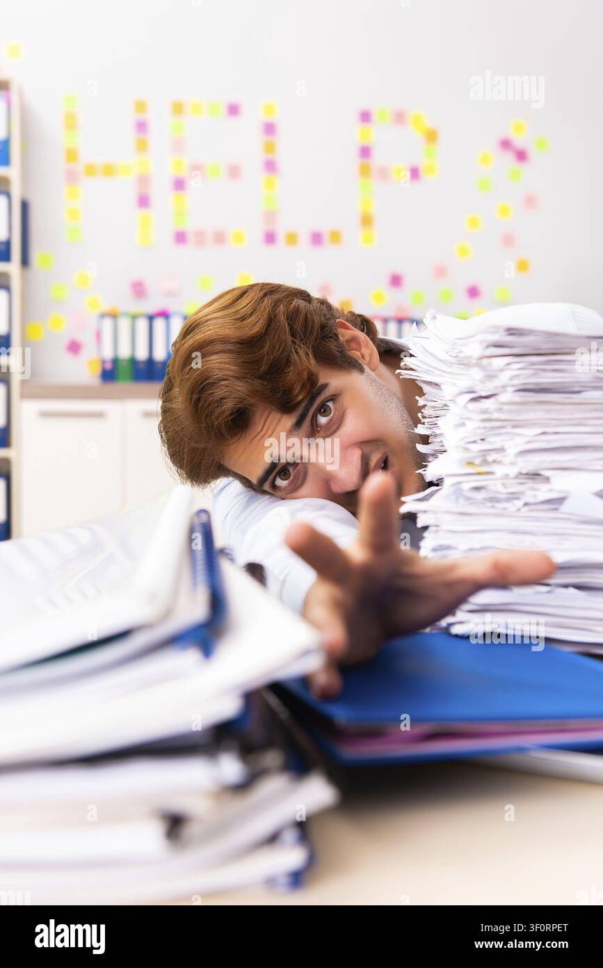 Young employee suffering from excessive work Stock Photo