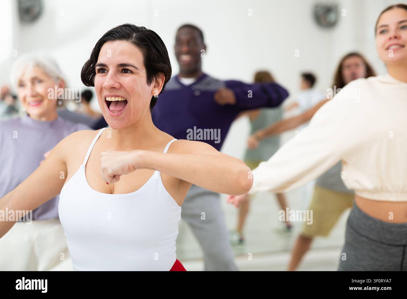 Group of dancing people practicing energetic swing Stock Photo