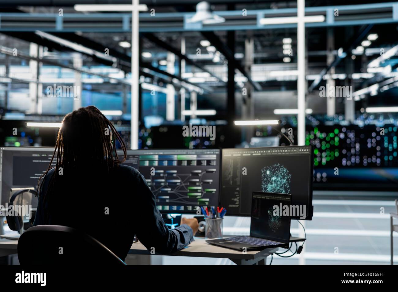 Data center IT professional reviews data analysis graph to reduce infrastructure failure. Stock Photo