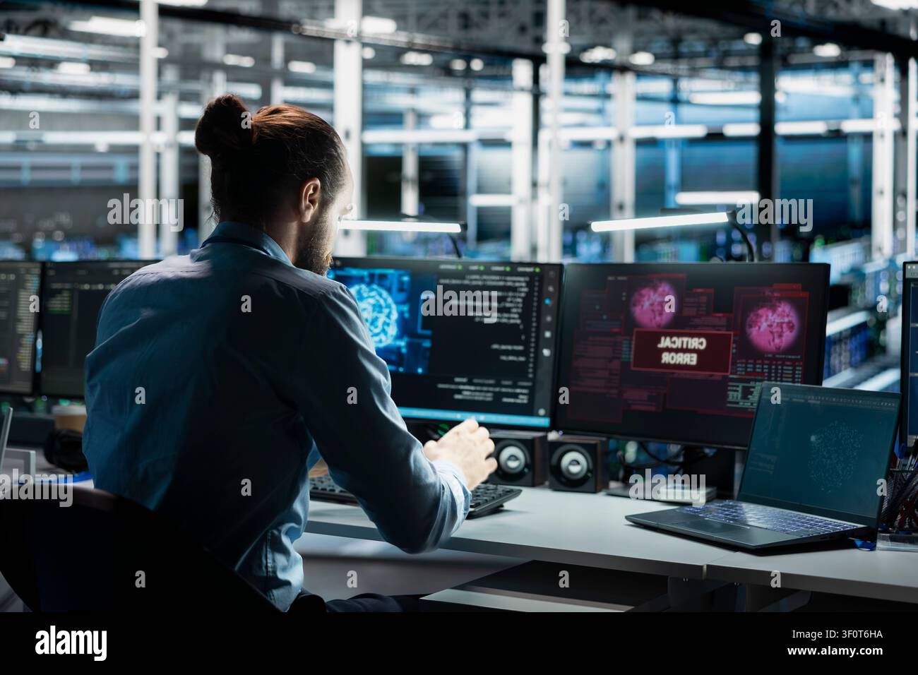 Server room computer scientist trying to fix system faults working with AI program. Stock Photo