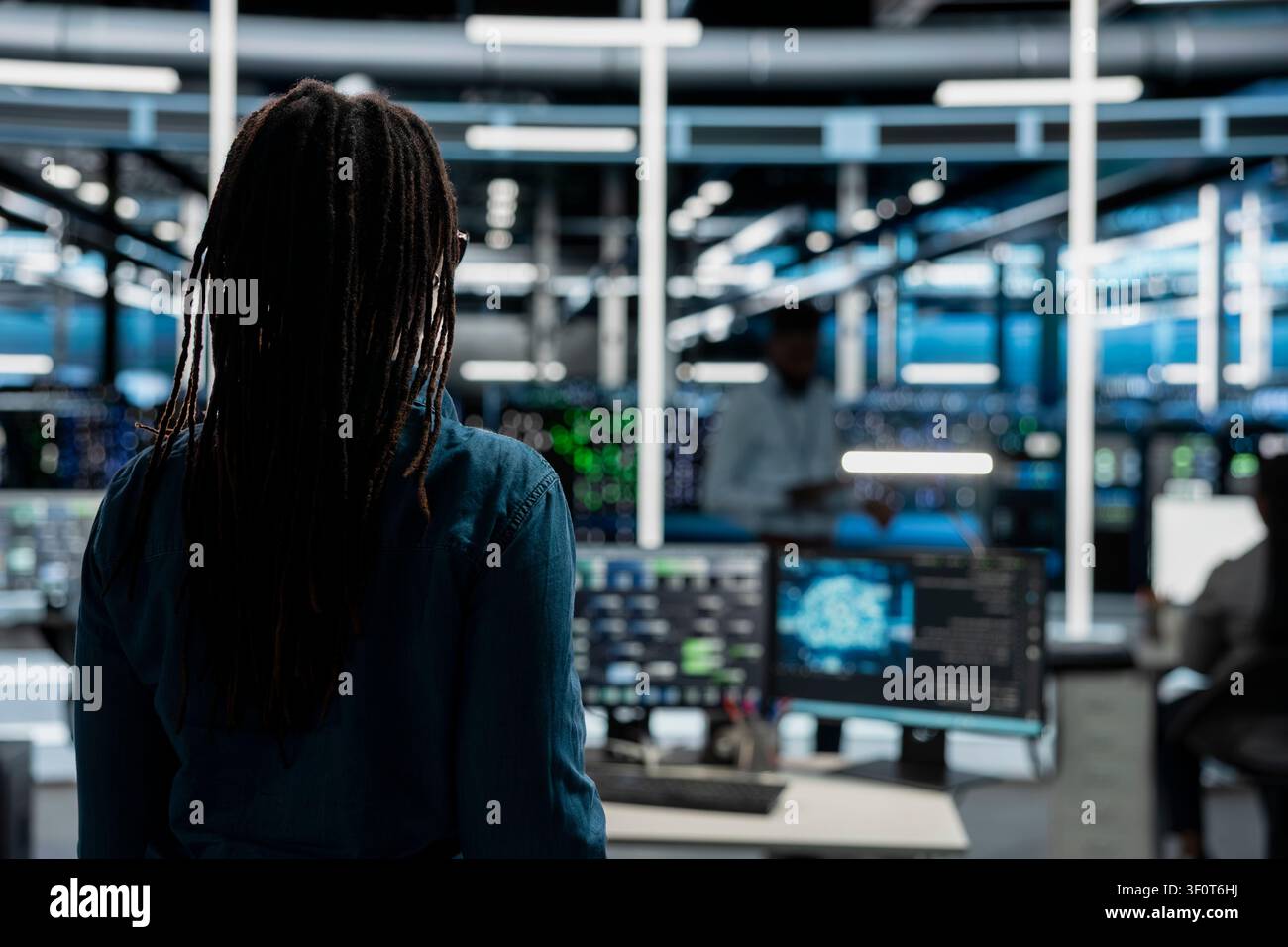 System administrator entering server room office, preparing to operate AI computerized model. Stock Photo