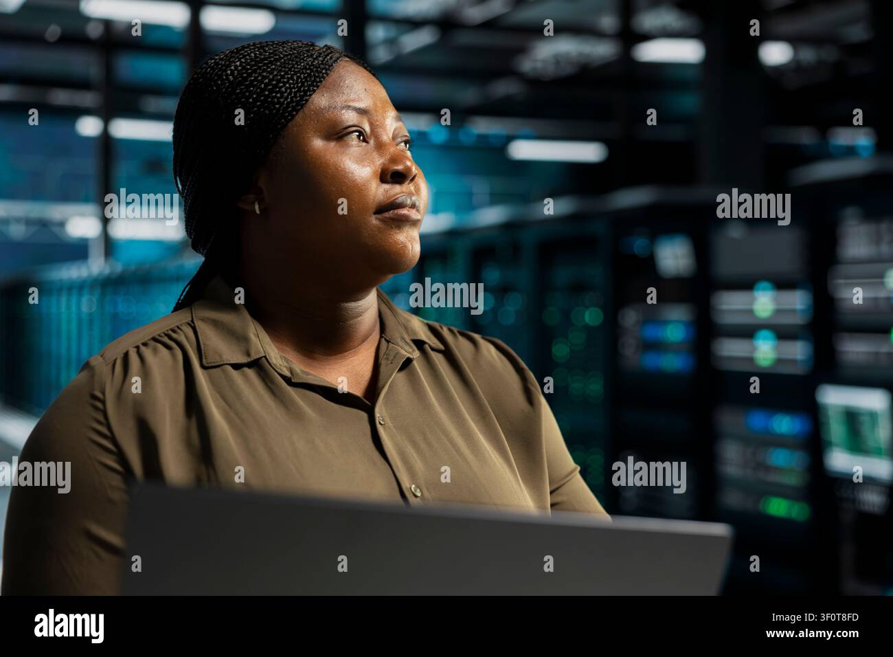 Coder doing maintenance on server facility electronics processing large datasets. Server environment staff member doing backups to protect infrastructure used by cloud storage hosting companies. Stock Photo