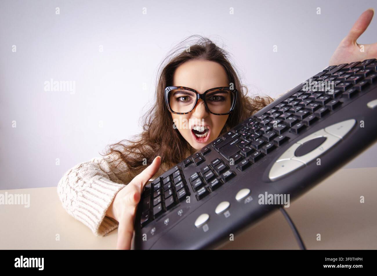 Funny nerd girl working on computer Stock Photo