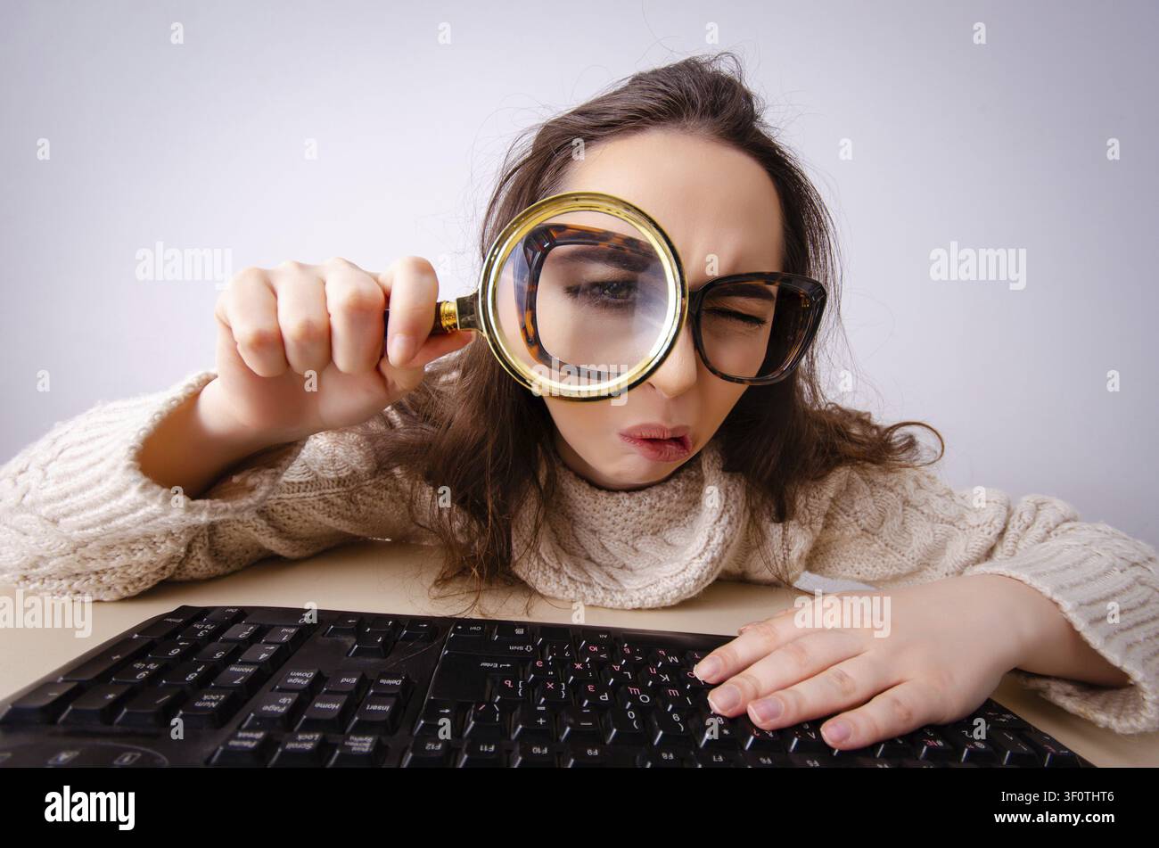 Funny nerd girl working on computer Stock Photo