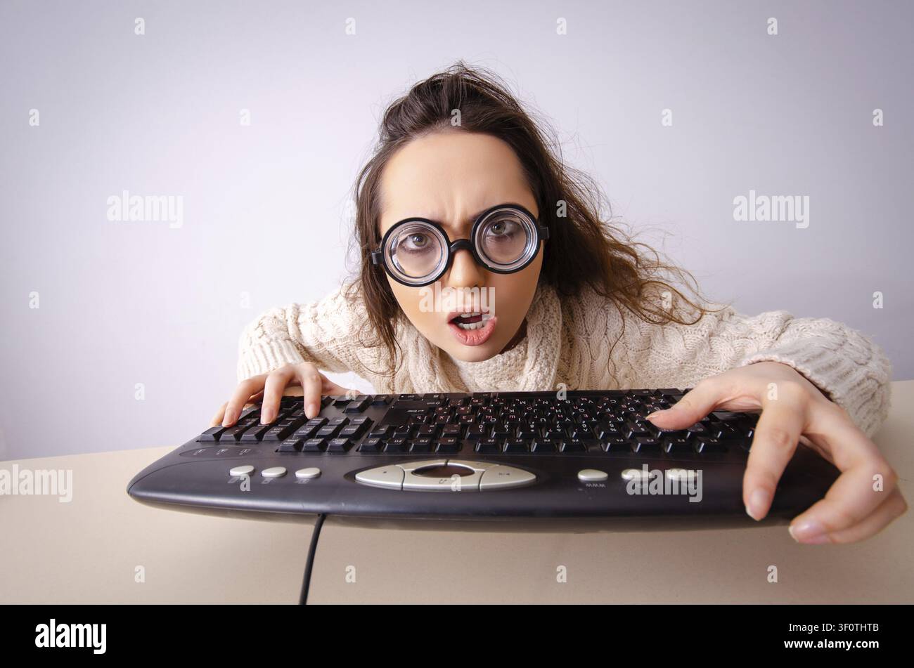 Funny nerd girl working on computer Stock Photo