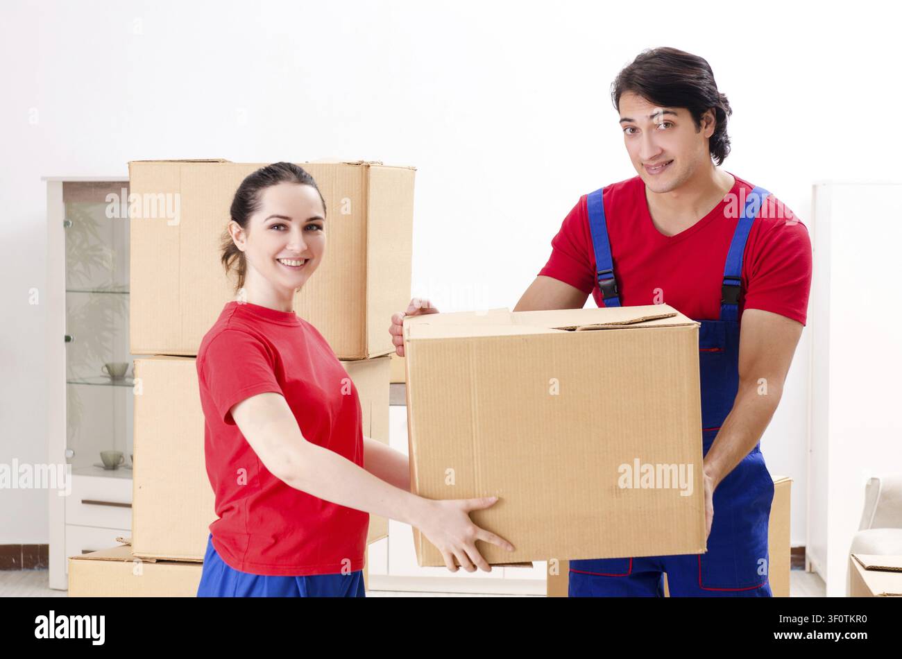 Professional movers doing home relocation Stock Photo