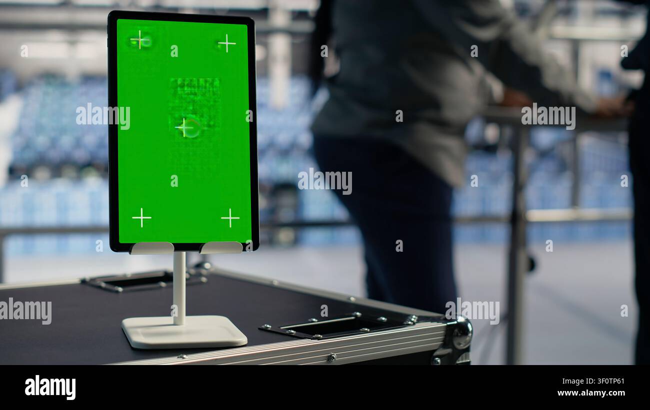 Data center worker works with a chroma key tablet, using an editable screen to manage machine learning workloads. Stock Photo