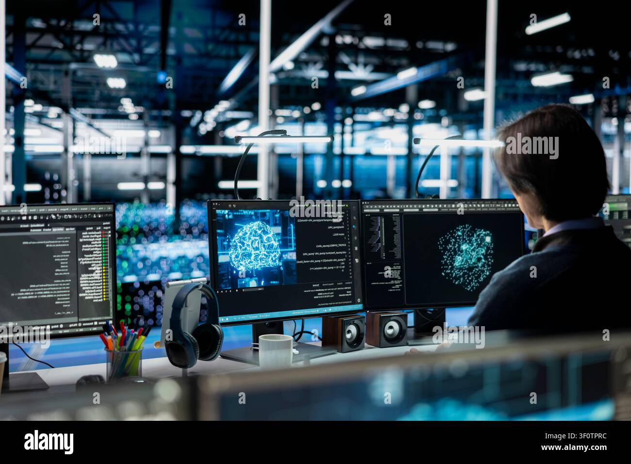 Server room admin running simulations for AI driven prediction, tracking performance. Stock Photo