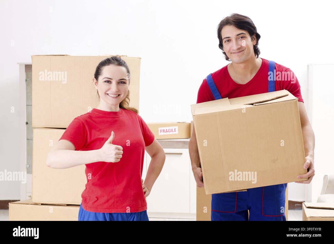 Professional movers doing home relocation Stock Photo