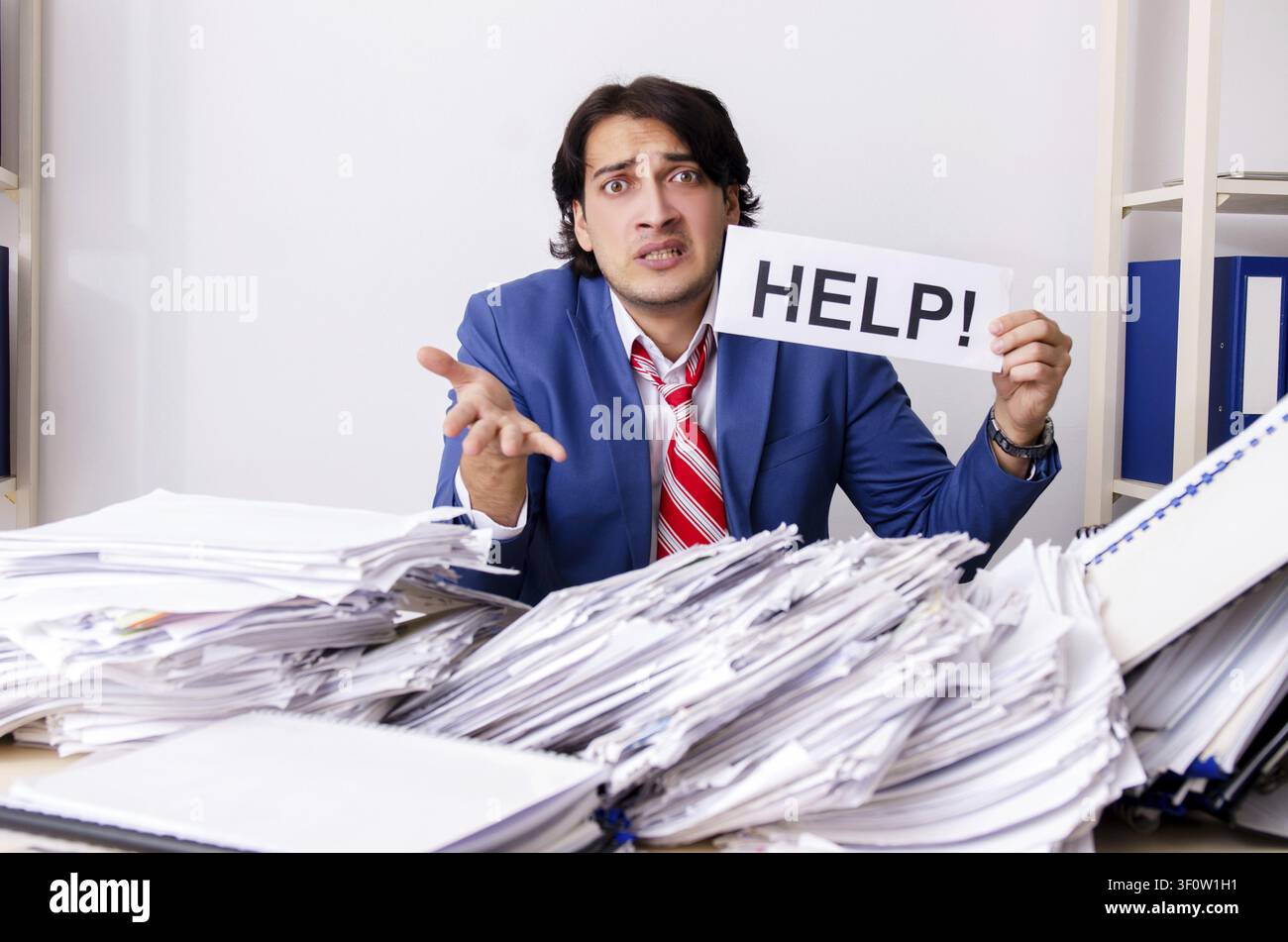 Young businessman employee unhappy with excessive work Stock Photo
