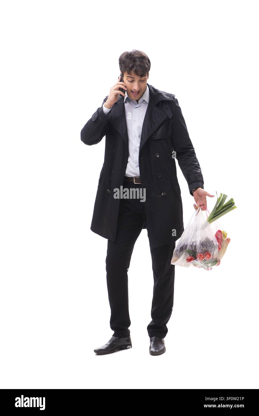 Young handsome man with vegatables in shopping concept Stock Photo