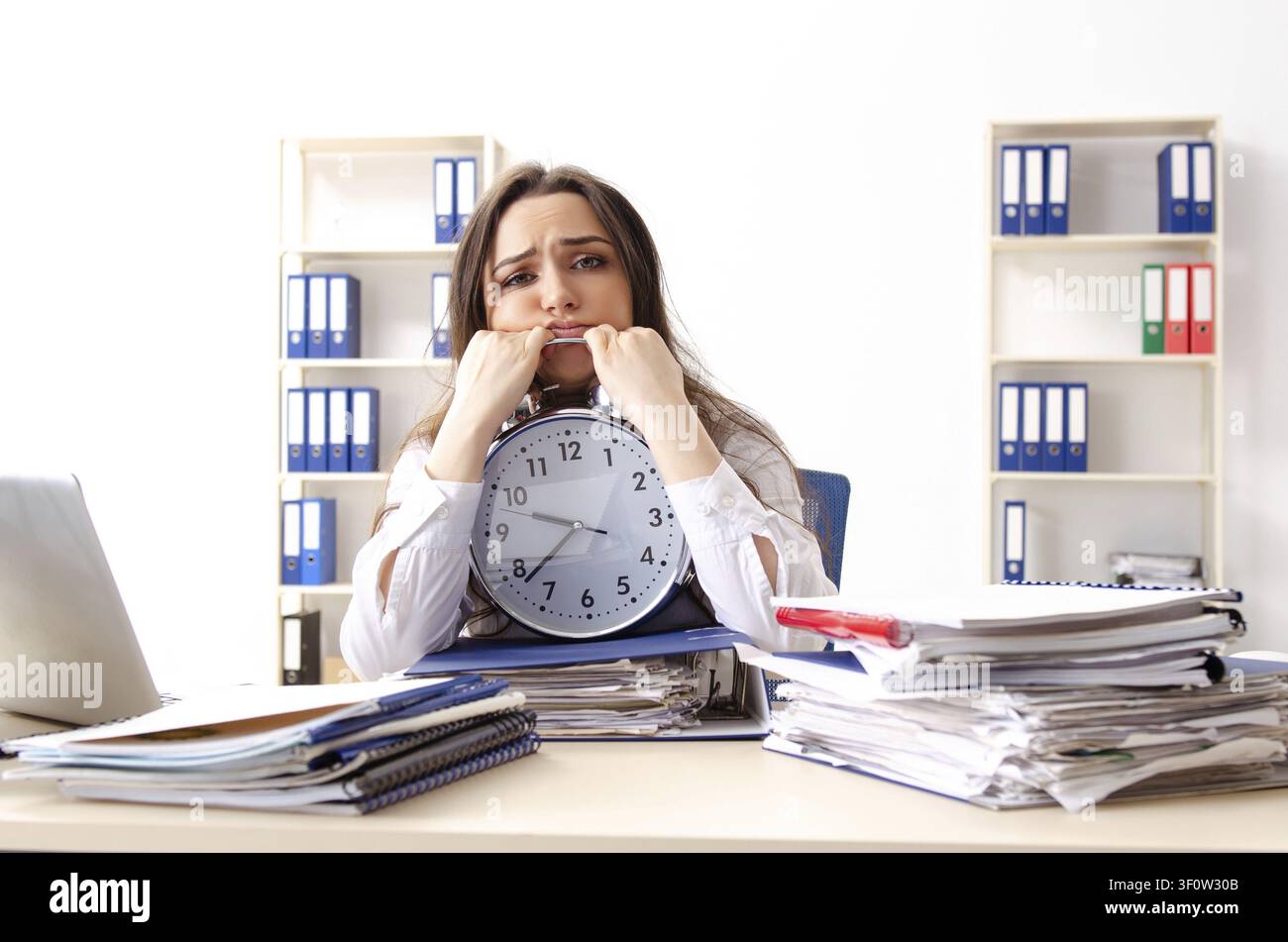 Young female employee unhappy with excessive work Stock Photo