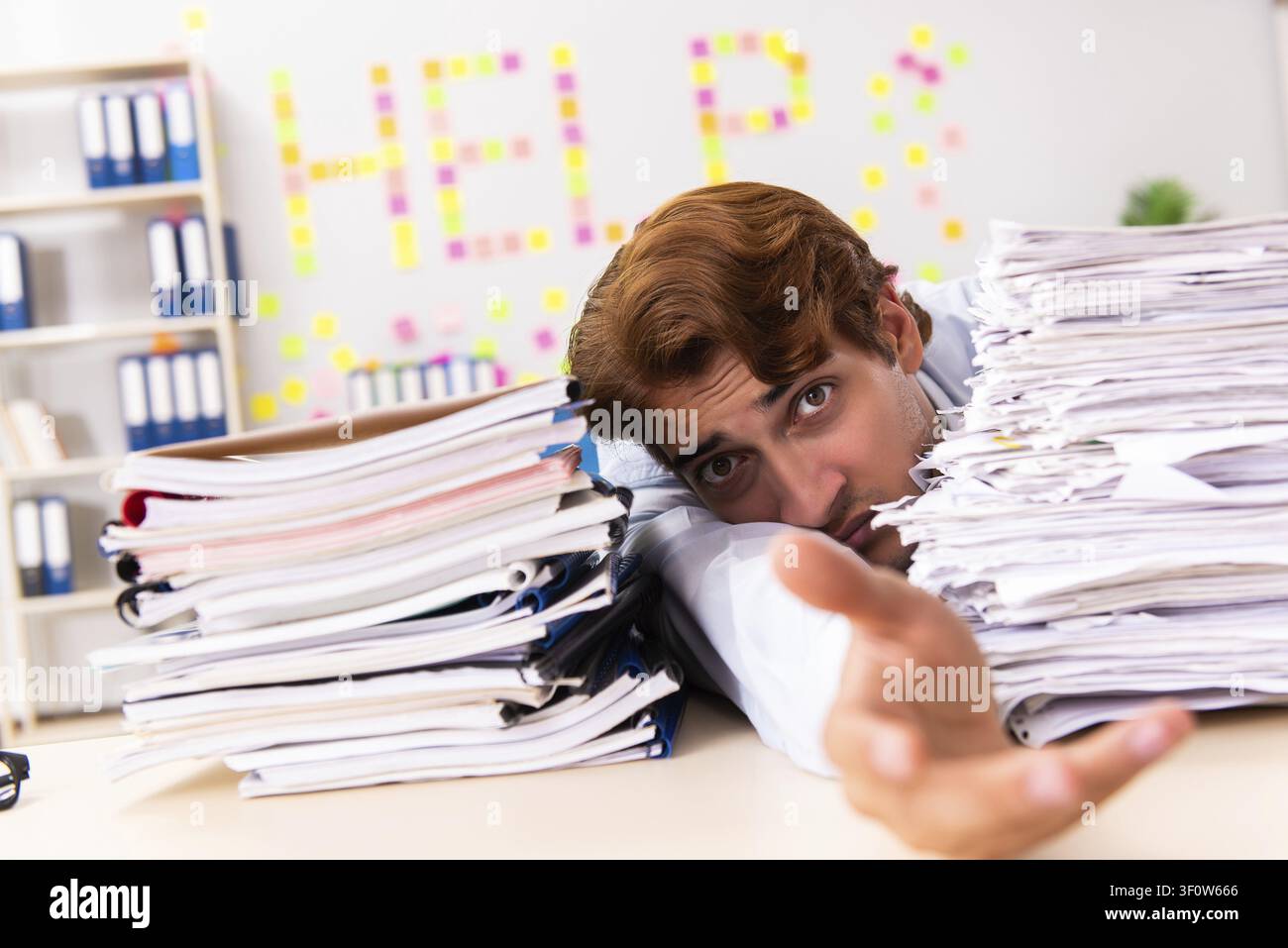 Young employee suffering from excessive work Stock Photo