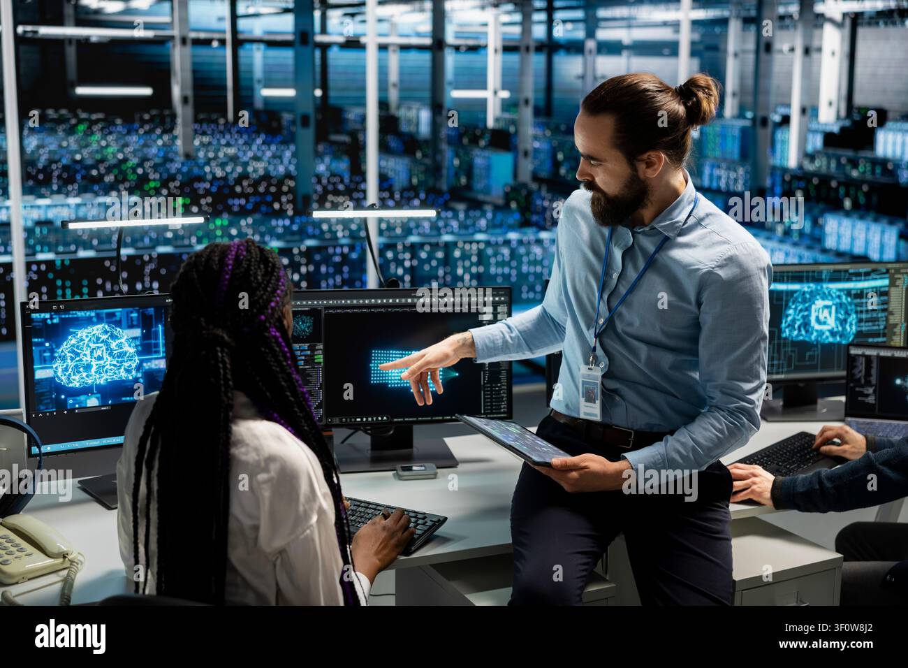 Engineer programs on a computer workstation in a data center with generative AI assistance. Stock Photo